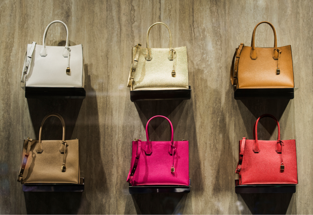 A display of six luxury handbags in various colors, highlighting different materials and finishes — ideal candidates for professional handbag restoration.
